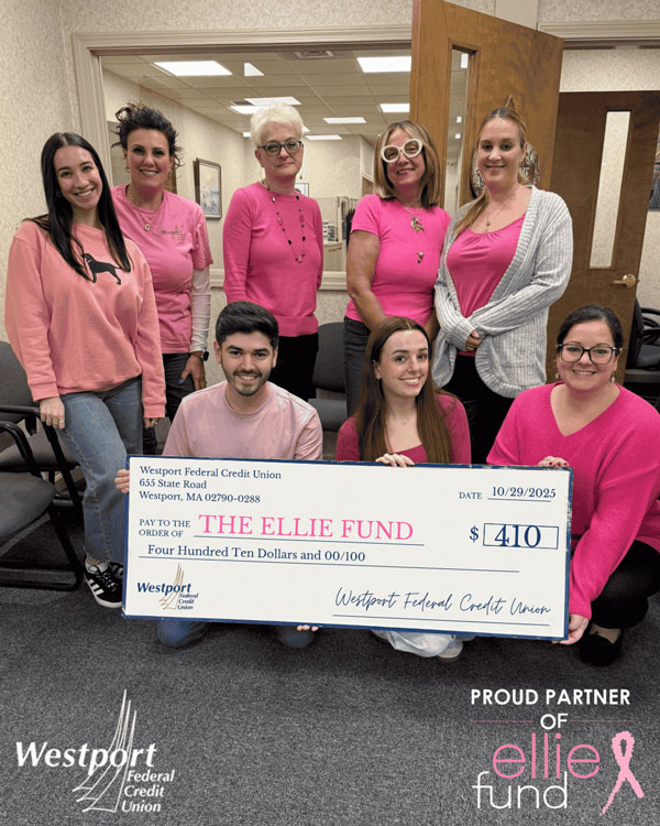Group photo of employees holding a large check for charity.