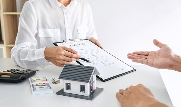 Agent showing house contract to client