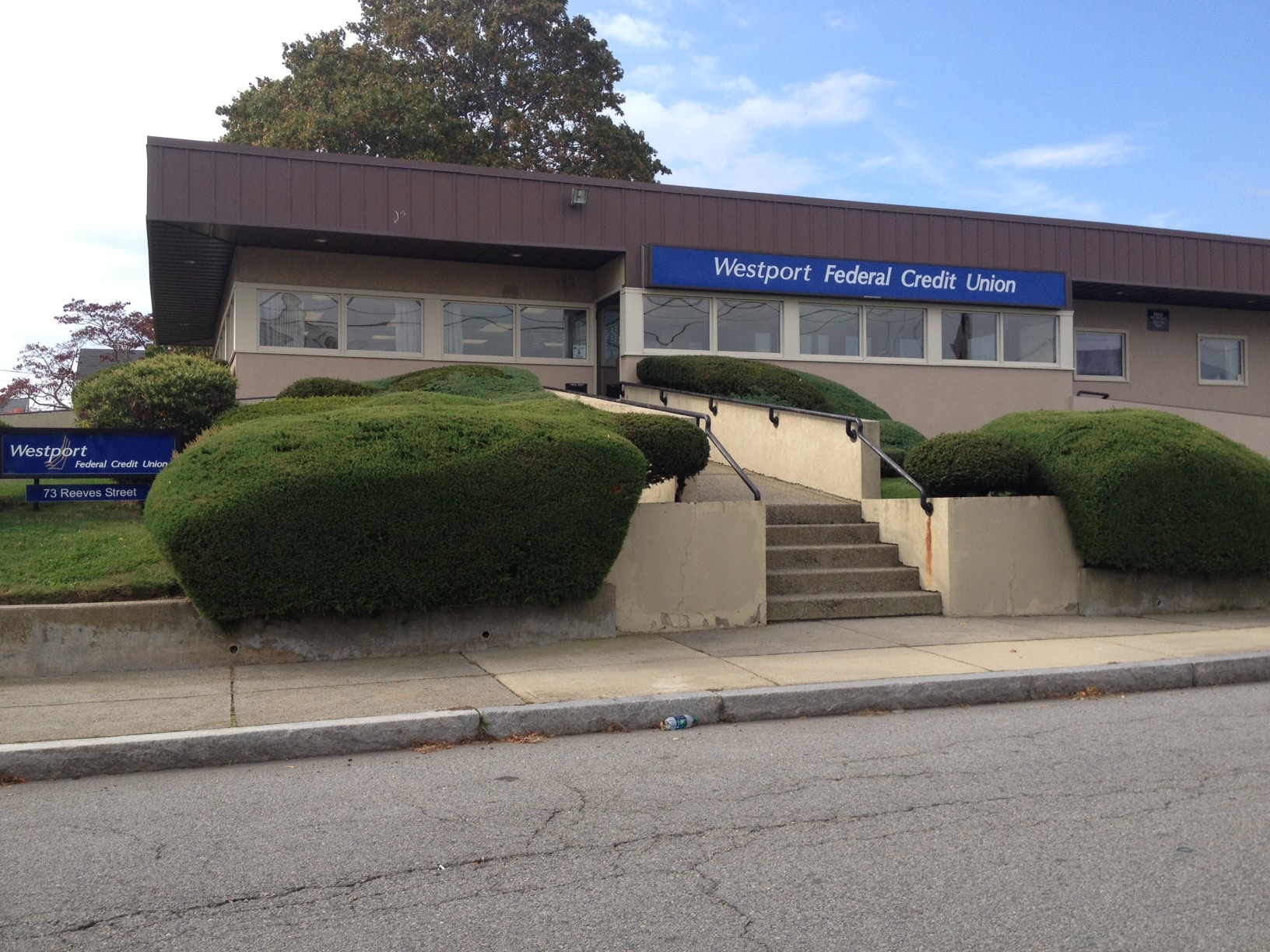Westport Federal Credit Union main office building with stairs and bushes.